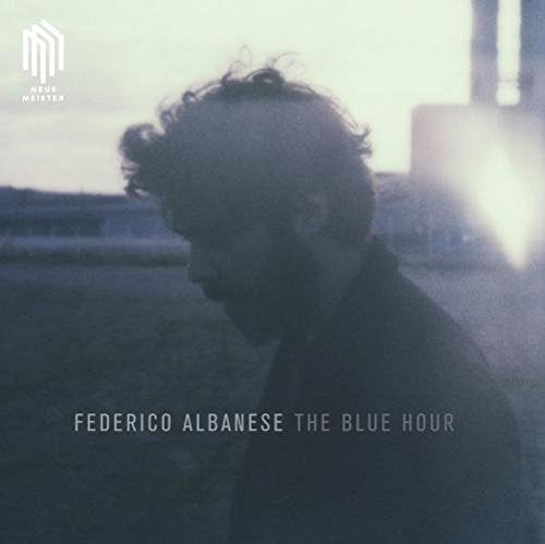Album cover with a man in silhouette against a blue-toned, blurred background.