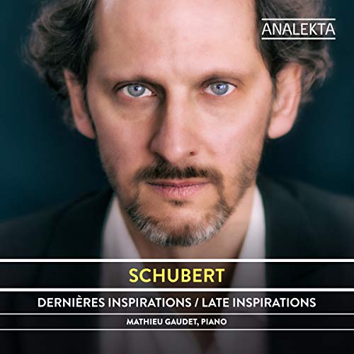 "CD cover featuring a man with blue eyes and a beard, wearing a suit."