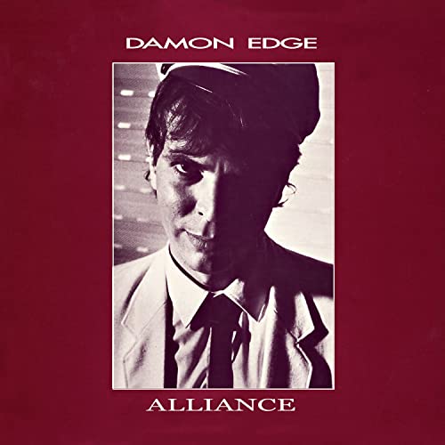 Vinyl album cover featuring a black and white portrait of a man in a cap.
