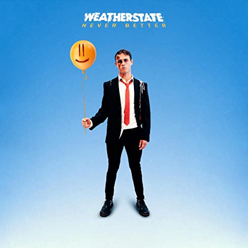 Man in suit holds a yellow balloon against a blue background.
