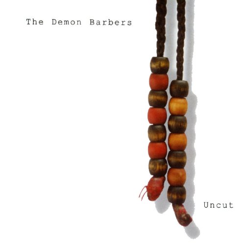 "Album cover with 'The Demon Barbers' and 'Uncut' text, featuring two braids with colored beads."