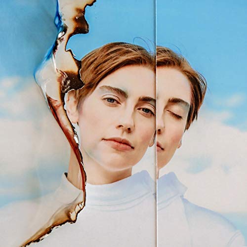 A split image of a woman with short hair against a blue sky background.