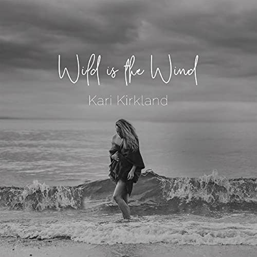 Black and white album cover featuring a woman by the ocean.