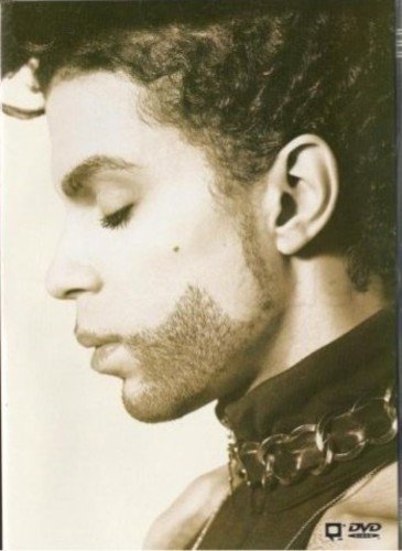 Sepia-toned portrait of a man with curly hair and a chain necklace.
