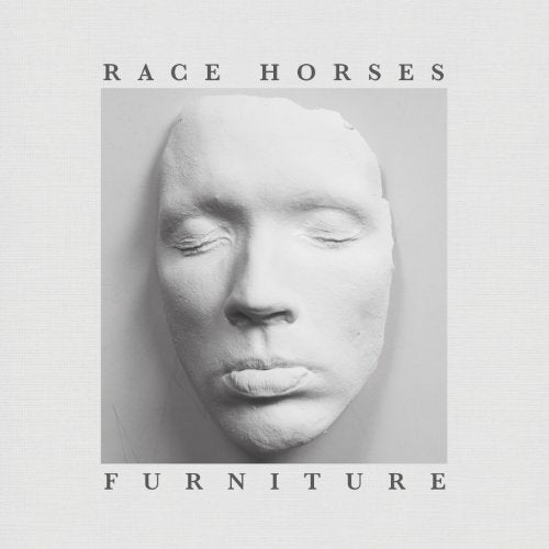 Black and white album cover featuring a plaster cast of a face.