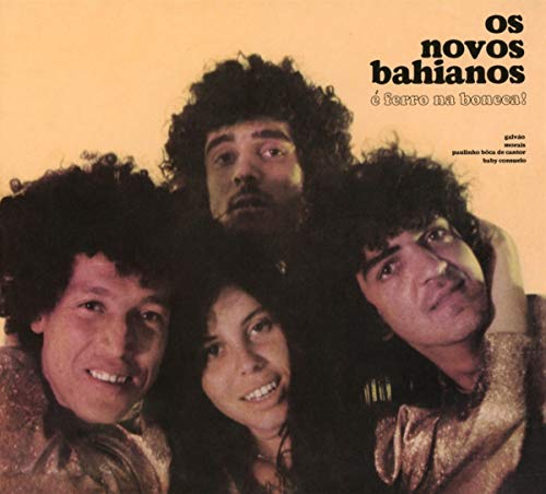 "CD cover featuring four people with curly hair against a beige background."