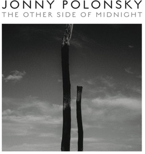 Jonny Polonsky album cover: dark, abstract image of tree trunks.