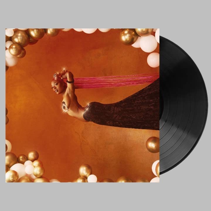 Vinyl record with album cover featuring a person surrounded by orbs.