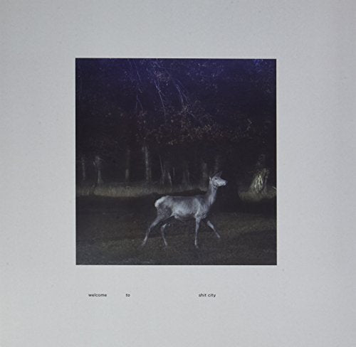 Vinyl album cover depicting a deer in a dark, wooded nighttime scene.