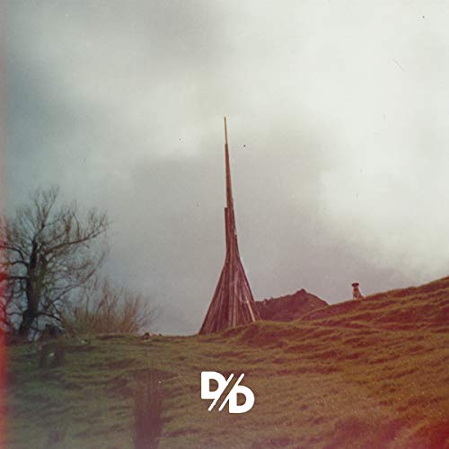 CD cover: Tall, wooden spire in a bleak, cloudy landscape.