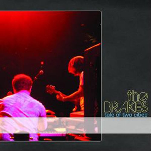 "Album cover with two musicians on stage, 'the BRAKES' and 'tale of two cities' text."