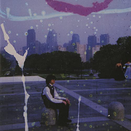 Album cover: man sitting before a city skyline with abstract effects.