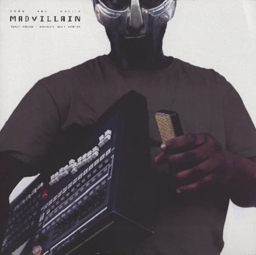 MF DOOM in a mask holds a black electronic calculator.