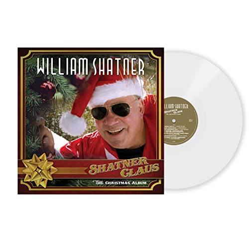 William Shatner in a Santa hat and red suit, vinyl record beside album cover.
