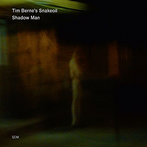 "Album cover with blurry figure in dark background, text 'Tim Berne's Snakeoil Shadow Man'."