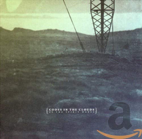CD cover with a tall metal tower against a hazy, mountainous landscape.