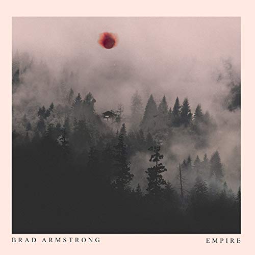 "Album cover featuring a misty forest with a red sun, artist and title displayed."