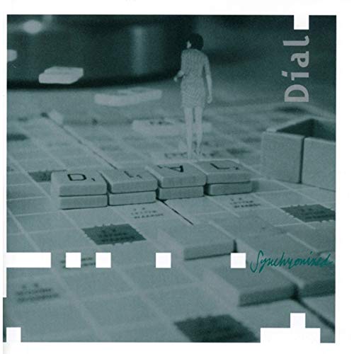 "Album cover with a miniature person standing on Scrabble tiles spelling 'DIAL' in a monochrome scene."