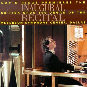 Man in a suit playing a large pipe organ, album cover.