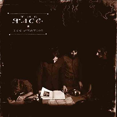 "Album cover with three men around a table, dark and distressed appearance."