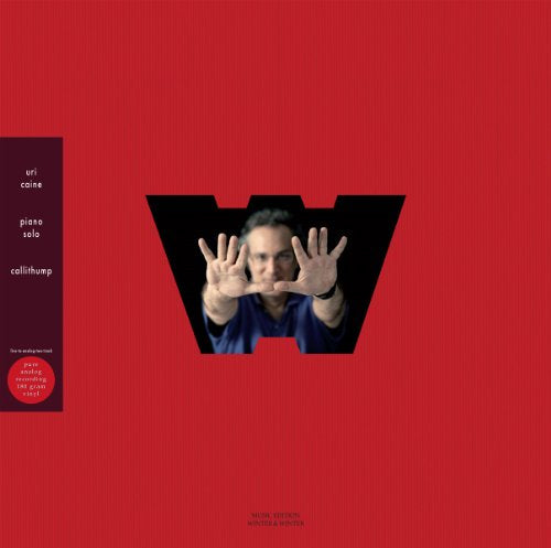 Red vinyl album cover featuring pianist Uri Caine with outstretched hands.