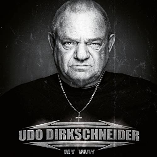 Black and white portrait of Udo Dirkschneider with album title text.