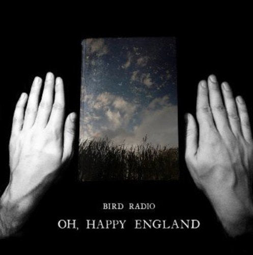 "CD cover with hands holding a book showing a grassy field and cloudy sky."