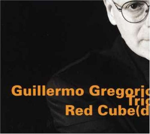 Album cover with a black-and-white photo of a man wearing glasses and dark clothing.
