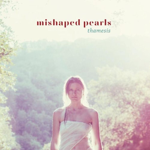 The alt text for the image is: "Album cover with a woman in a white dress outdoors."
