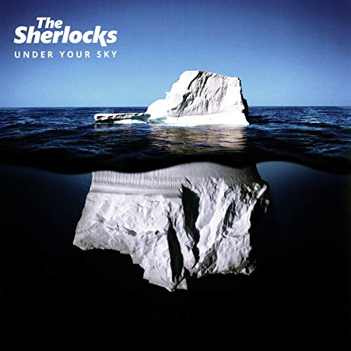 The image shows an iceberg, partially submerged in water, with the album title "Under Your Sky" by "The Sherlocks" written above it. Alt text: Iceberg partially submerged in blue water with album title and artist name.
