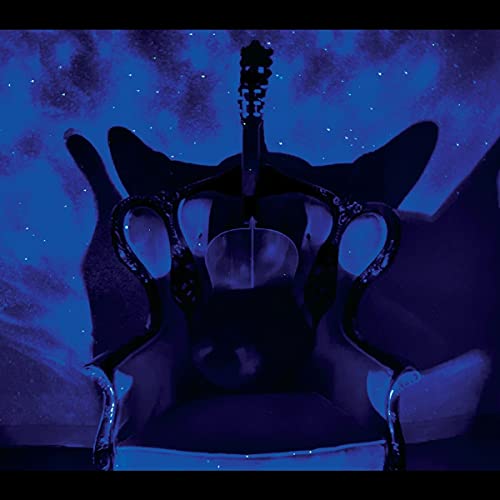 Guitar headstock and body on a pillow, against a starry blue background.