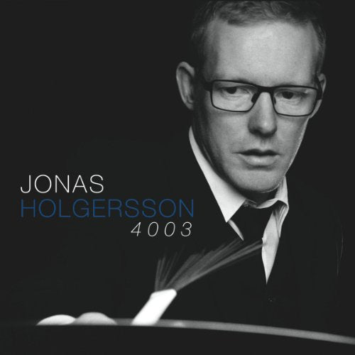 Black and white portrait of Jonas Holgersson with piano keys.