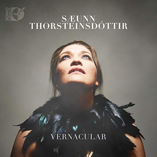 CD cover: woman looking up, framed by dark feathers, album title "Vernacular".