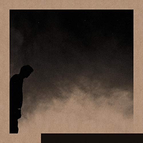 Dark album cover featuring a silhouetted figure against a cloudy sky.