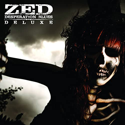 Album cover for Zed’s “Desperation Blues Deluxe” featuring a distorted face.