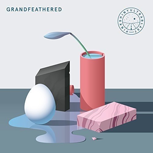 Album cover with egg, black box, pink cylinder, and marble block in abstract scene.