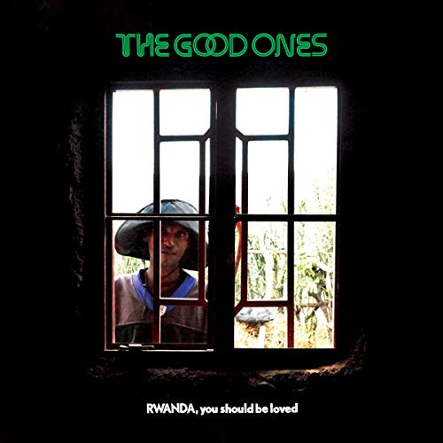 Album cover with a man in a hat seen through a barred window.