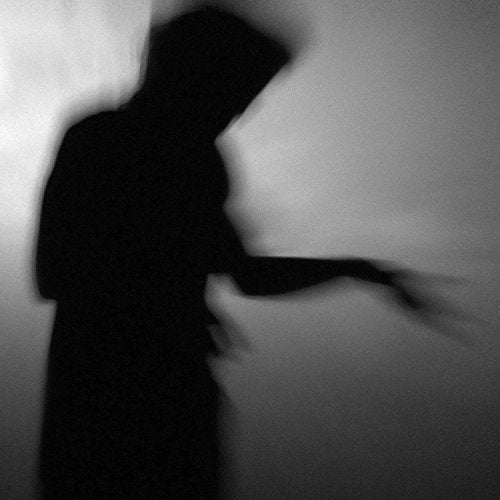 Blurry black and white image of a person with outstretched arm.