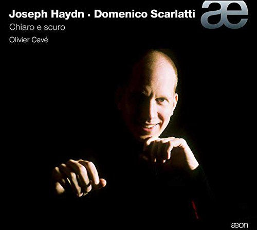 A CD cover featuring a man with a contemplative expression, surrounded by dark background.