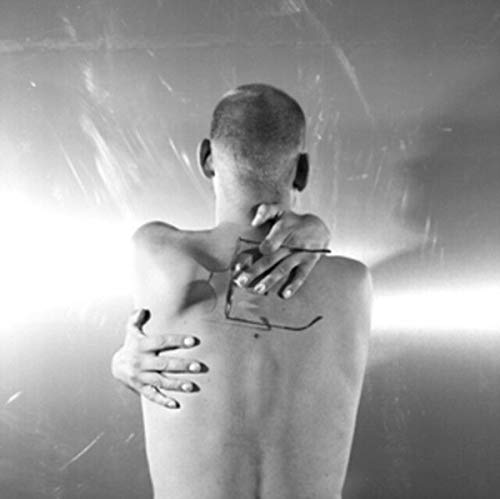 Black and white album cover featuring a man’s back with drawn lines.