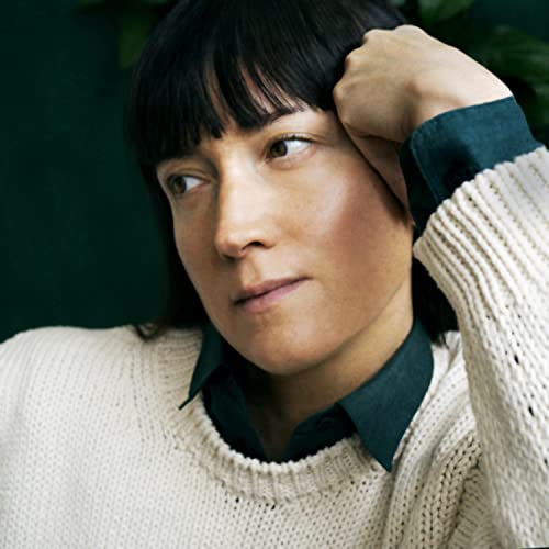 Close-up portrait of a woman with dark hair and a knitted sweater.