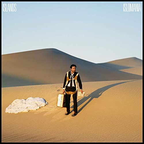 Vinyl album cover: man with suitcase in a desert landscape.