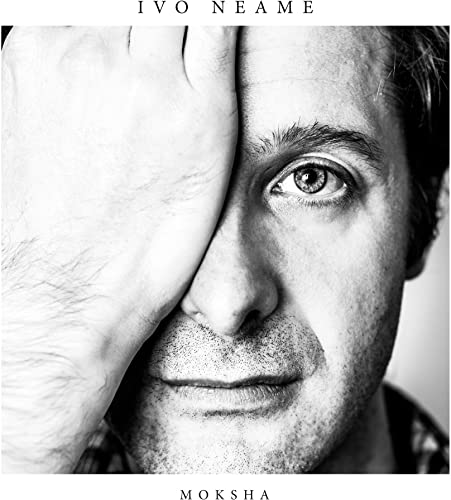 Black and white CD cover featuring a man partially obscuring his face.