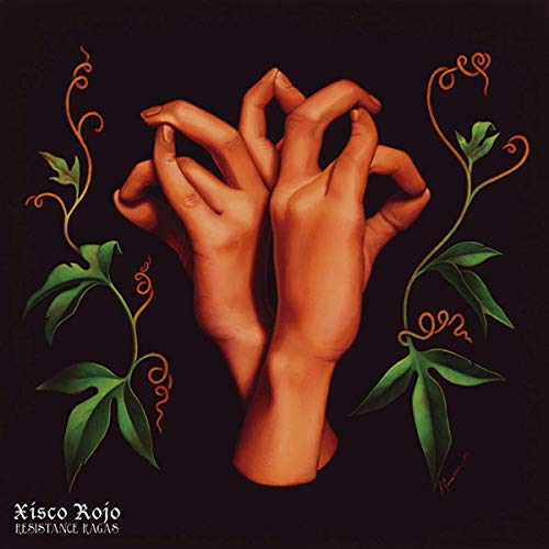 Painted hands in mudra pose with green vines on black background.