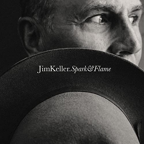 Black and white portrait of a man wearing a hat, album cover.