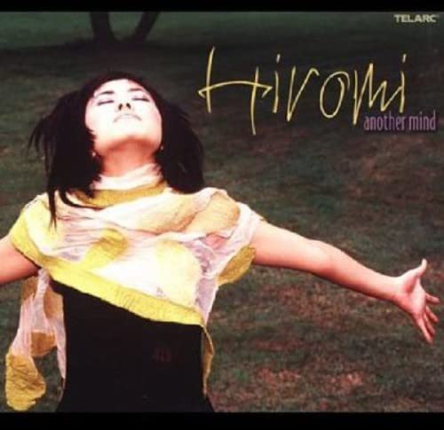 CD cover: Hiromi, a woman with arms outstretched, in a field.