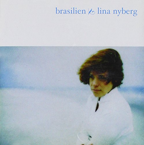 Album cover with a woman in white against a blue background, artist's name displayed.