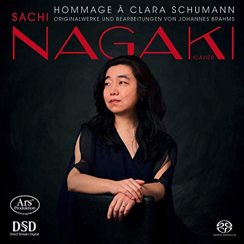 CD cover featuring a woman in a black dress with red text and dark background.