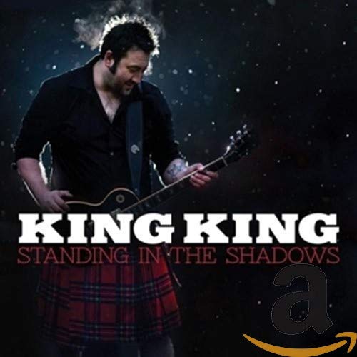 Man playing guitar in a kilt, album cover for King King.