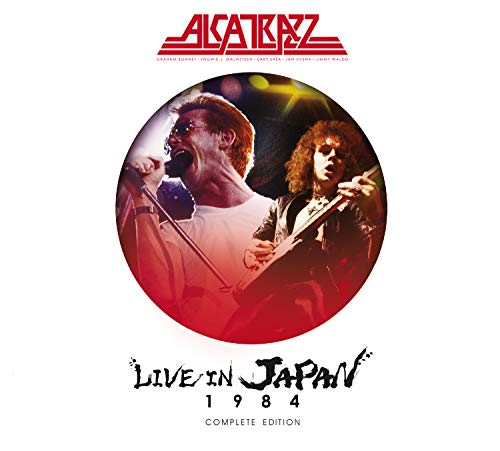 "Album cover with red circular image of two musicians performing on stage."